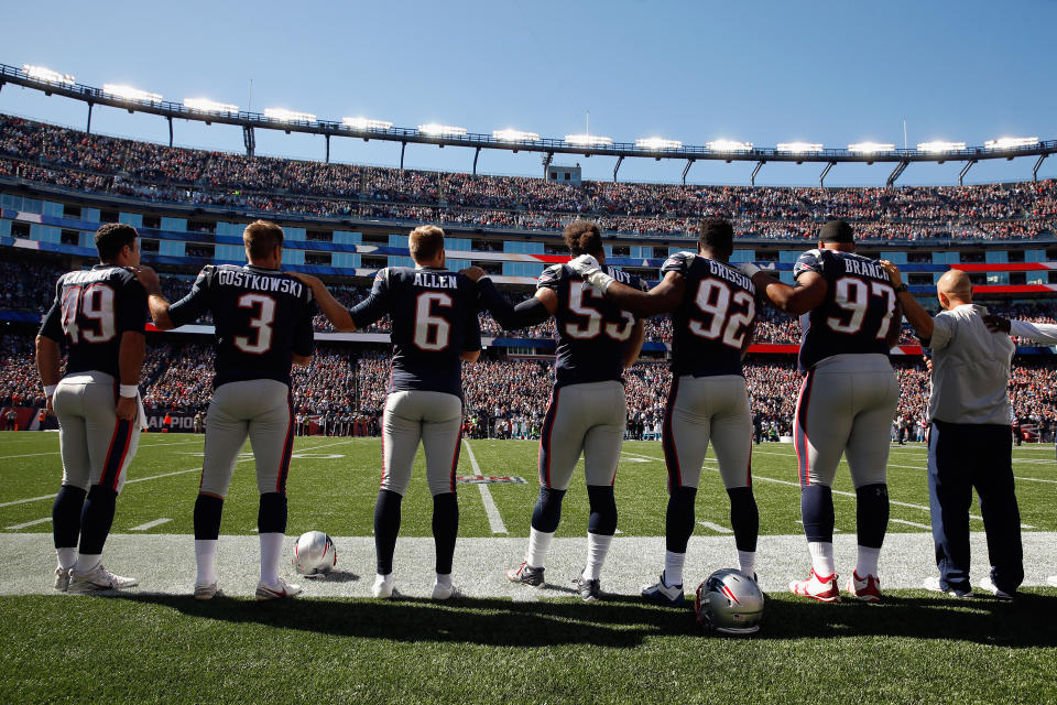 <p>New England Patriots players stand for the national anthem before their game against the Carolina Panthers at Gillette Stadium on October 1, 2017 in Foxboro, Massachusetts. (Photo by Jim Rogash/Getty Images) </p>