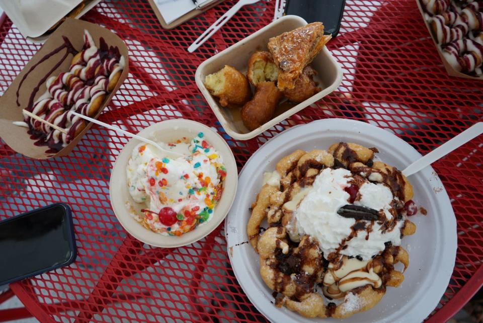 Clockwise from top: Tempura fried bananas from Lucky Lucky Dumpling Co., Oreos Cookies and Cream funnel cake from LT's Gold Done Funnel Cakes and a Caramel on the Rocks sundae from Guiltless Concessions at the 58th annual Festival of the Arts in downtown OKC’s Bicentennial Park.