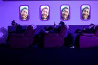 People look at their phones during Alibaba Group's 11.11 Singles' Day global shopping festival at a media center in Hangzhou