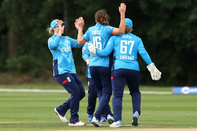 Kate Cross (centre) is mobbed by her team-mates 