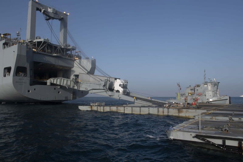 A truck with humanitarian aid drives down the ramp from the MV Benavides onto the roll-on/roll-off discharge facility platform in May. File Photo via U.S. Army/UPI