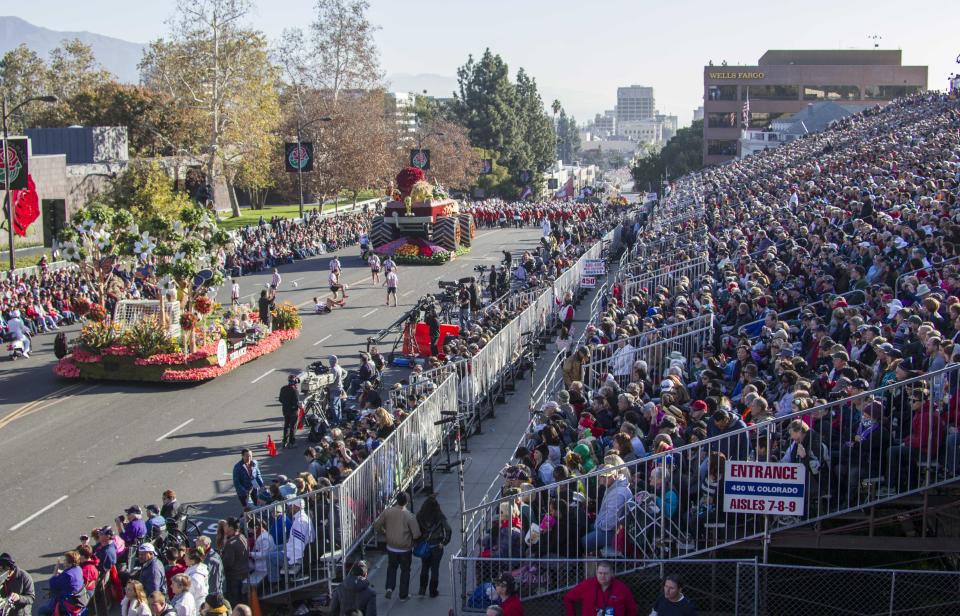 Spectators and floats are seen during the 125th Tournament of Roses Parade in Pasadena, Calif., Wednesday, Jan. 1, 2014. (AP Photo/Ringo H.W. Chiu)