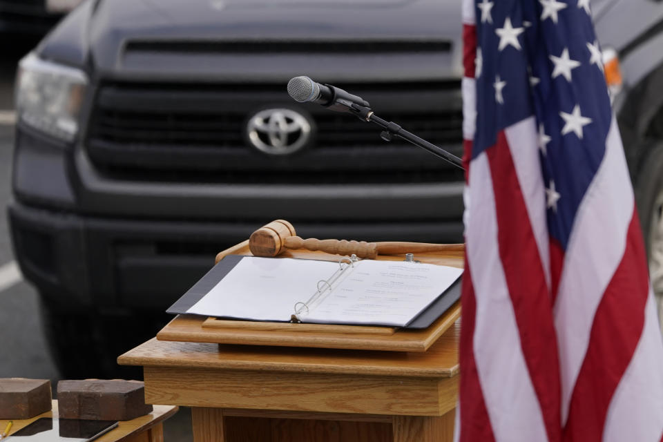 The House Speaker's gavel rests on a podium prior to an outdoor meeting of the New Hampshire House of Representatives in a parking lot, due to the COVID-19 virus outbreak, at the University of New Hampshire Wednesday, Jan. 6, 2021, in Durham, N.H. The legislative group gathered to begin business for the new year, which included again electing a House Speaker, after the death in December 2020 of newly-elected House Speaker Dick Hinch, who died of COVID-19. (AP Photo/Charles Krupa)