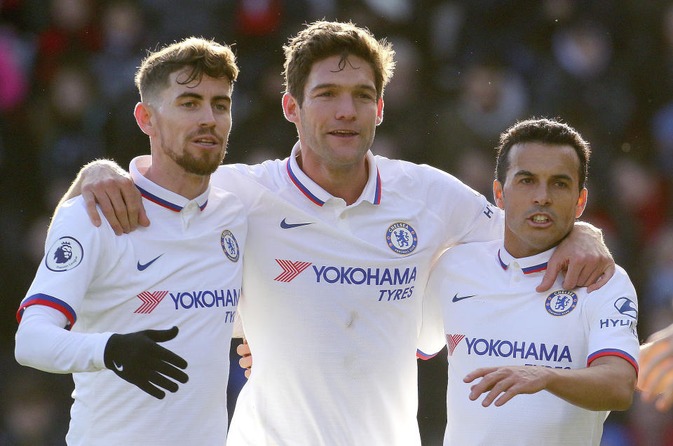 Chelsea's Marcos Alonso, centre, celebrates with team-mates Jorginho, left, and Pedro after scoring his side's first goal of the game against Bournemouth, in the English Premier League soccer match at the Vitality Stadium in Bournemouth, England, Saturday Feb. 29, 2020. (Mark Kerton/PA via AP)
