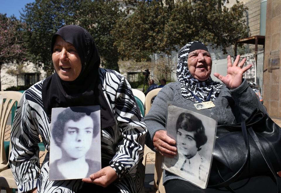 Lebanese Halimeh Jamal, 72, right, whose son, Rashid, went missing in 1976, holds her son's portrait while sitting next to Majida Bashasha, 60, left, who holds a portrait of her brother Ahmad who was kidnapped in 1975 at the age of 18, as they attend the ninth anniversary of an ongoing sit-in, in front the U.N headquarters in downtown Beirut, Lebanon, Friday April 11, 2014. Rashid and Ahmad are among an estimated 17,000 Lebanese still missing from the time of Lebanon’s civil war or the years of Syrian domination that followed. Syria’s civil war has added new urgency to the plight of their families, many of whom are convinced their loved ones are still alive and held in Syrian prisons, at risk of being lost or killed in the country’s mayhem(AP Photo/Hussein Malla)