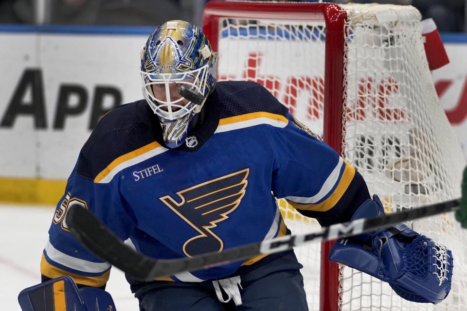 St. Louis Blues goaltender Jordan Binnington keeps his eye on the puck during the first period of an NHL hockey game against the Minnesota Wild Wednesday, March 15, 2023, in St. Louis. (AP Photo/Jeff Roberson)