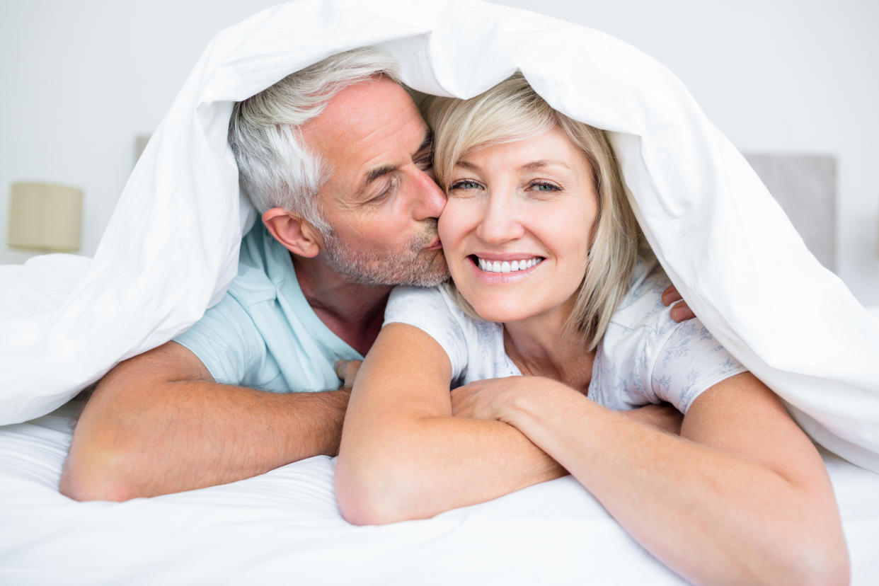 Older couple lying in bed together as an illustration of menopause sex