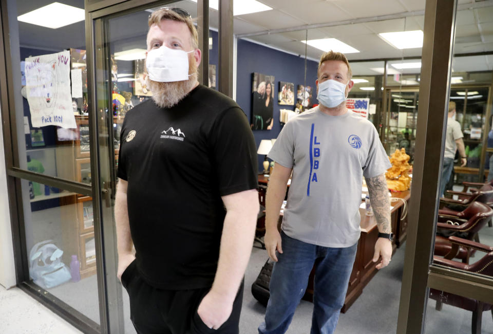 Twin brothers Whit Melton, left, and Wes Melton pose for a photo at their martial arts daycare summer camp in Richardson, Texas, Tuesday, May 19, 2020. As daycare and youth camps re-open in Texas, operators are following appropriate safety measure to insure kids stay safe from COVID-19. (AP Photo/LM Otero)