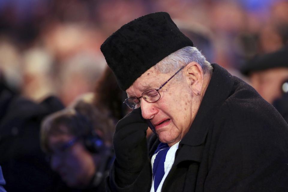 A survivor reacts at a ceremony on the site of the former Nazi German concentration and extermination camp Auschwitz-Birkenau near Oswiecim