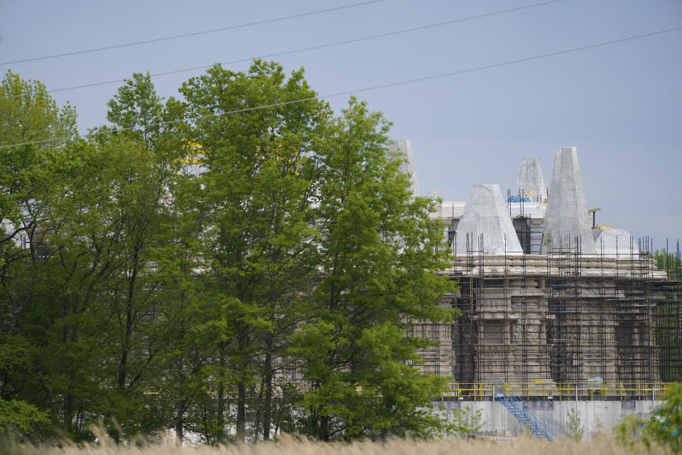 A part of the BAPS Shri Swaminarayan Mandir is covered in scaffolding in Robbinsville Township, N.J., Tuesday, May 11, 2021. A lawsuit claims workers from marginalized communities in India were lured to New Jersey and forced to work more than 12 hours per day at slave wages to help build a Hindu temple. (AP Photo/Seth Wenig)