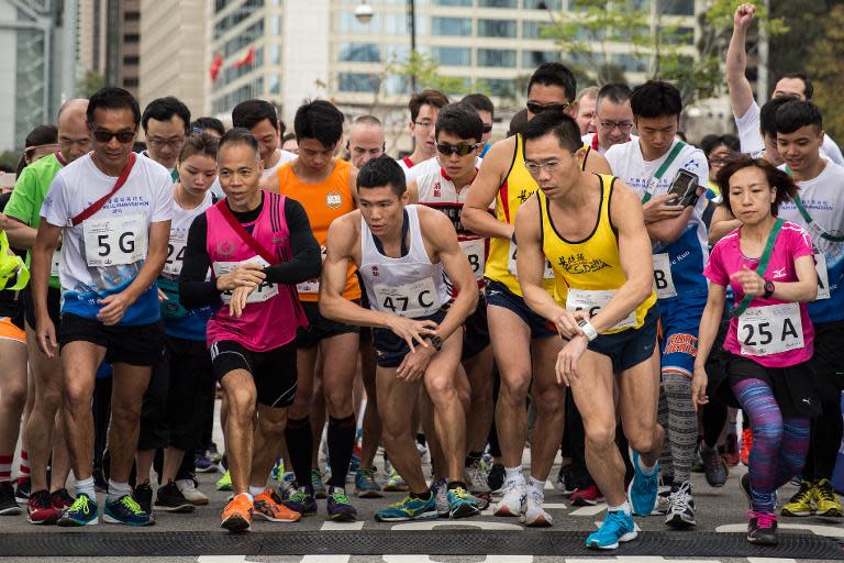 Competitors start a relay race along the same course as Hong Kong's first inner city ultra marathon, on March 1, 2015