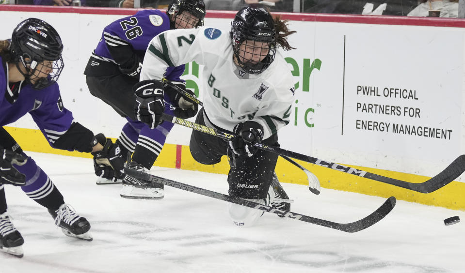 Minnesota's Mchela Cava, left, and Kendall Coyne Schofield (26) chase down Boston's Emily Brown (2) in the first period of Game 4 of the PWHL Walter Cup hockey finals in St. Paul, Minn., on Sunday, May 26, 2024. (Richard Tsong-Taatarii/Star Tribune via AP)