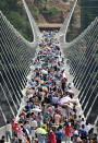 <p>8,000 tourists queued overnight before Saturday’s trial opening to be the first to step onto the Zhangjiajie Grand Canyon’s glass-bottomed bridge. (Getty Images)<br></p>