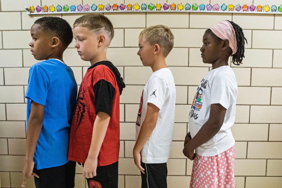 Students form a line in the hallway on the first day of school at Pleasantville Elementary School near New Castle, Aug. 28, 2023.