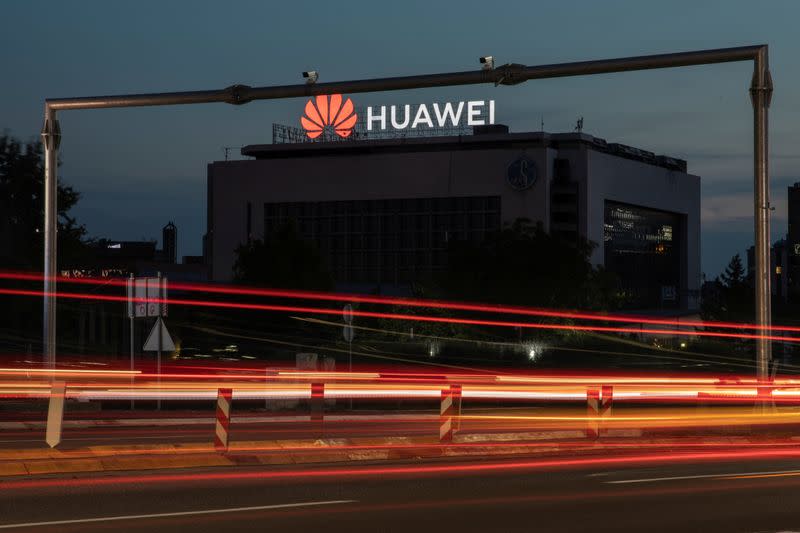 Surveillance cameras are seen in front of a Huawei logo in Belgrade