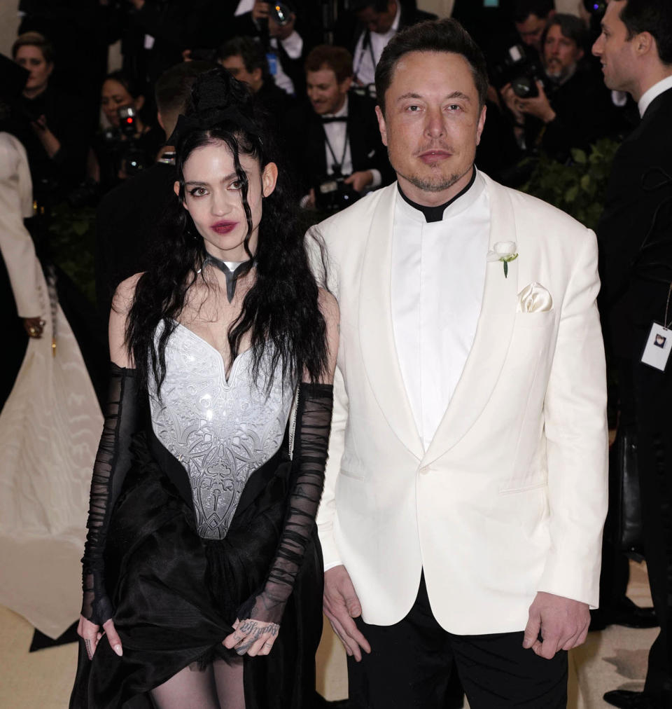 Musical artist Grimes and Tesla founder Elon Musk pose for a photo. (Source: AP)