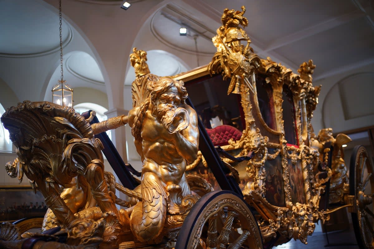 The Gold State Coach is displayed at the Royal Mews (PA)