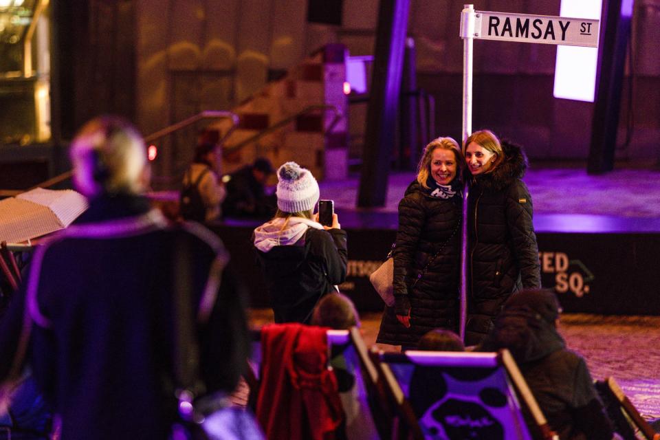 Fans react during a screening of the final episode of Australian TV soap, Neighbours, at Federation Square in Melbourne, Australia, Thursday, July 28, 2022. After 37 years the final episode of Australia's longest-running TV show was broadcast in Australia. (Diego Fedele/AAP via AP)