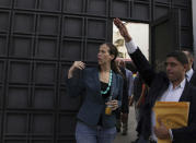 FILE - In this Aug. 3, 2017 file photo, opposition lawmaker Manuela Bolivar, left, enters the Venezuelan General Prosecutor's office to introduce a petition asking for an investigation into the recent constituent assembly elections in Caracas, Venezuela. "It's time that this generation took a step forward against totalitarianism and took the reins in the fight," Bolivar tweeted in 2018. (AP Photo/Wil Riera, File)