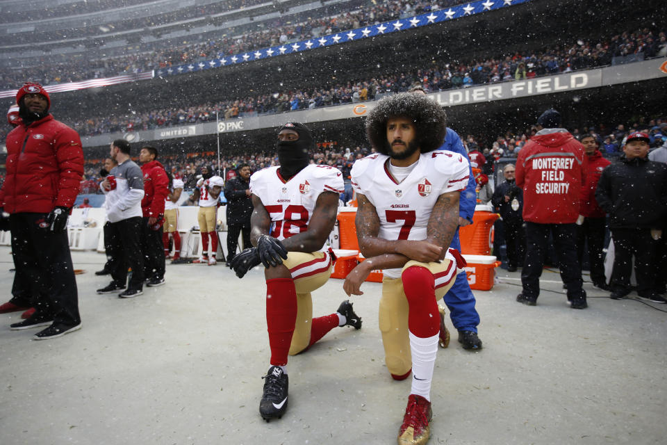 CHICAGO, IL - DECEMBER 4: Eli Harold #58 and Colin Kaepernick #7 of the San Francisco 49ers kneel on the sideline, during the anthem, prior to the game against the Chicago Bears at Soldier Field on December 4, 2016 in Chicago, Illinois. The Bears defeated the 49ers 26-6. (Photo by Michael Zagaris/San Francisco 49ers/Getty Images)