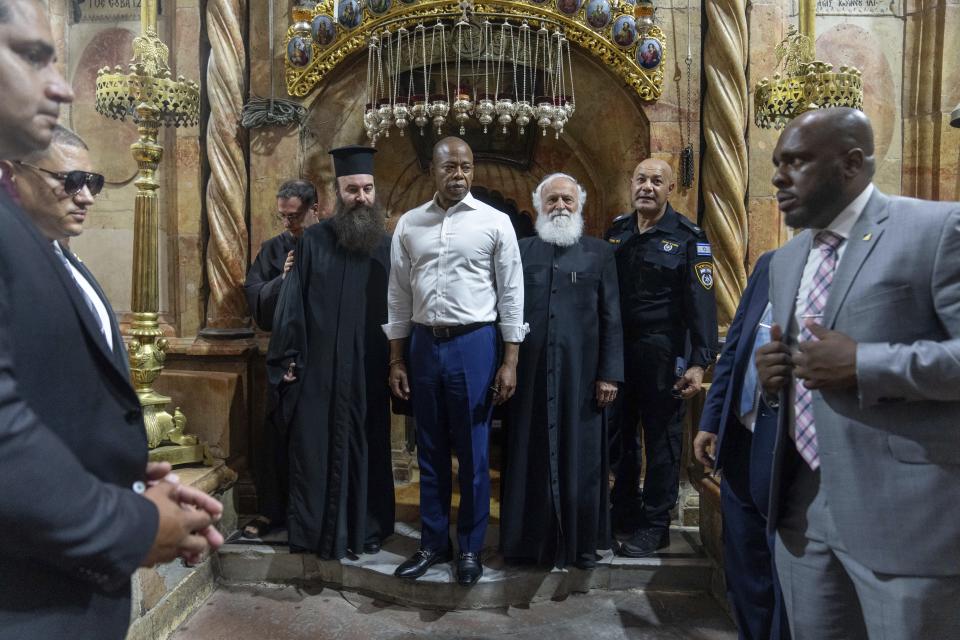 Mayor Eric Adams of New York, center, visits the Church of the Holy Sepulcher in Jerusalem, Tuesday, Aug. 22, 2023. Adams spent the second day of his visit to Israel touring holy sites before a planned meeting with Prime Minister Benjamin Netanyahu as he sought to avoid publicly weighing into the political crises plaguing the nation. (AP Photo/Ohad Zwigenberg)