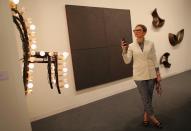 MIAMI BEACH, FL - DECEMBER 05: Evelina Khromtchenko looks at the art in a gallery as Art Basel opens at the Miami Beach Convention Center on December 5, 2012 in Miami Beach, Florida. The 11th edition of the art show runs from December 6 through the 9th. (Photo by Joe Raedle/Getty Images)