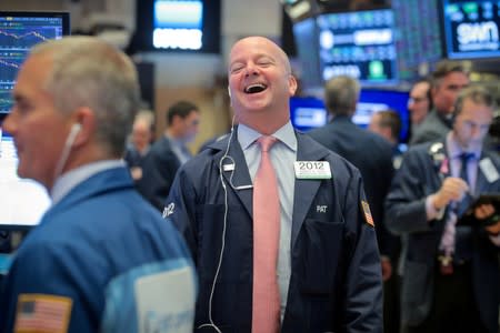 FILE PHOTO: Traders work on the floor at the NYSE in New York