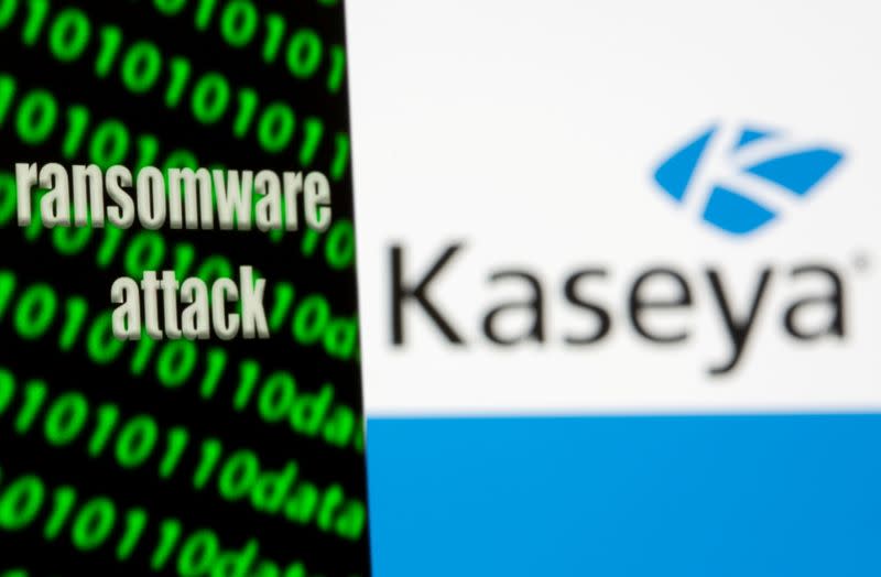 FILE PHOTO: A smartphone with the words "Ransomware attack" and binary code is seen in front of the Kaseya logo