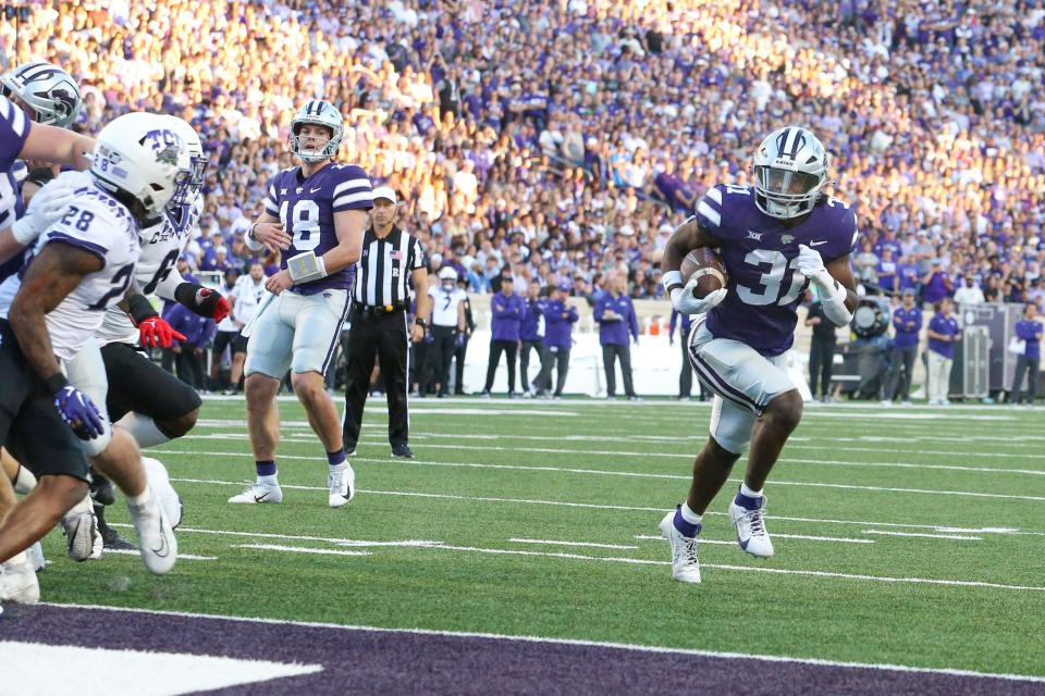 Kansas State running back DJ Giddens (31) scores a first-quarter touchdown against TCU on Saturday night at Bill Snyder Family Stadium.