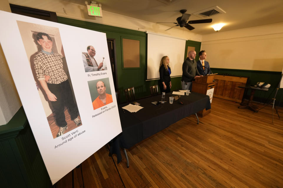 Scott Verti, center back, is flanked by his lawyers, Mara Essick, left, and Kurt Zaner, as Verti responds to questions during a news conference at the Denver Press Club on Thursday, Jan. 19, 2023, in Denver. Verti, who says he was repeatedly sexually abused as a teenager by a Catholic priest while serving as an altar boy in a parish in Fort Collins, Colo., is suing that defrocked priest and the Archdiocese of Denver. (AP Photo/David Zalubowski)