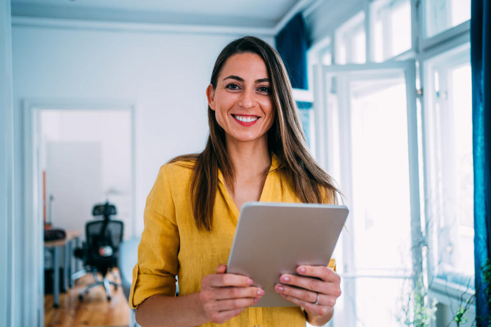 Woman with tablet working from home