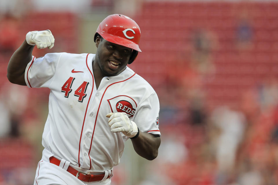 Cincinnati Reds' Aristides Aquino reacts as he runs the bases after hitting a solo home run during the third inning of a baseball game against the New York Mets in Cincinnati, Tuesday, July 20, 2021. (AP Photo/Aaron Doster)