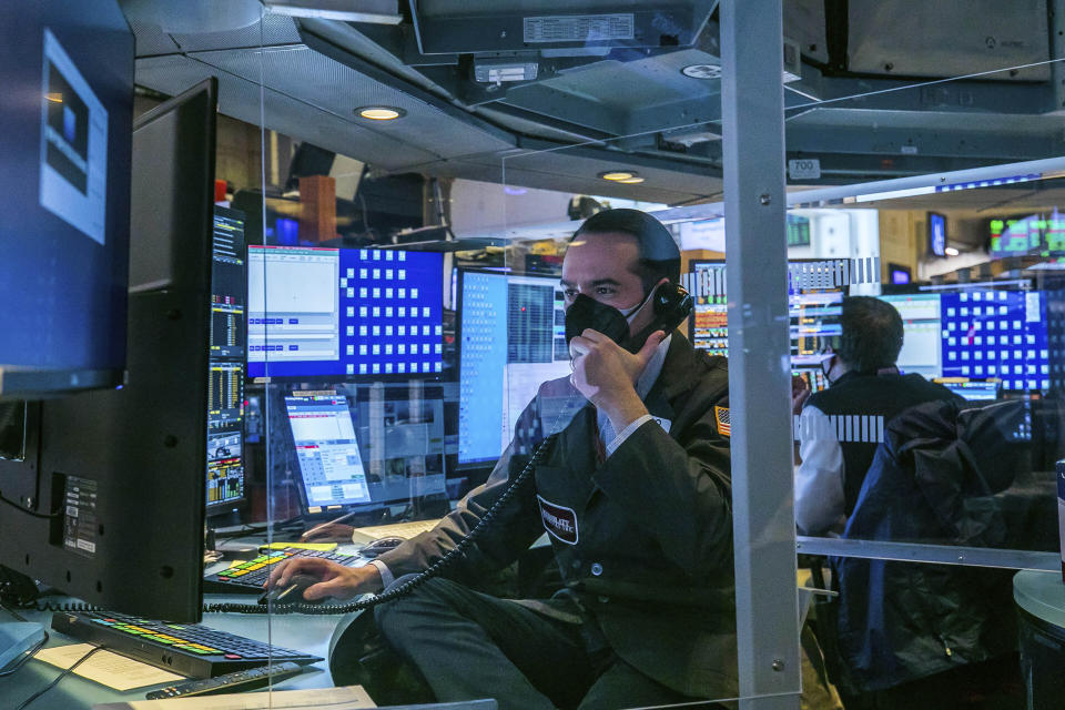 In this photo provided by the New York Stock Exchange, traders work on the floor, Monday, March 1, 2021. Stocks are rising across the board on Wall Street as traders welcomed a move lower in long-term interest rates in the bond market. Investors were also watching Washington as a big economic stimulus bill moved to the Senate. (Courtney Crow/New York Stock Exchange via AP)