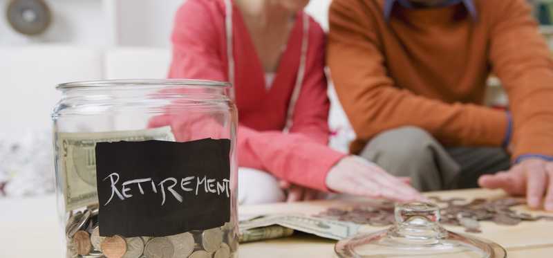 A couple counts out the coins from their retirement jar.