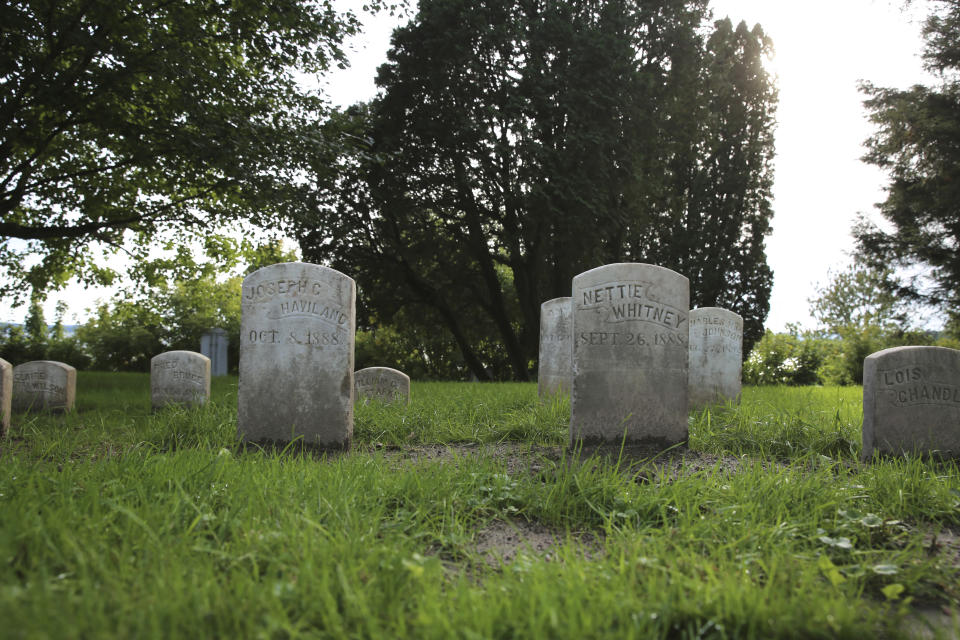 Headstones of children who at died in the late 1800s and early 1900s at the Home for Destitute Children, in Burlington, Vt., are shown, Wednesday, Sept. 21, 2022. Volunteers recently restored the gravestones, resetting, straightening and cleaning them. (AP Photo/Lisa Rathke)