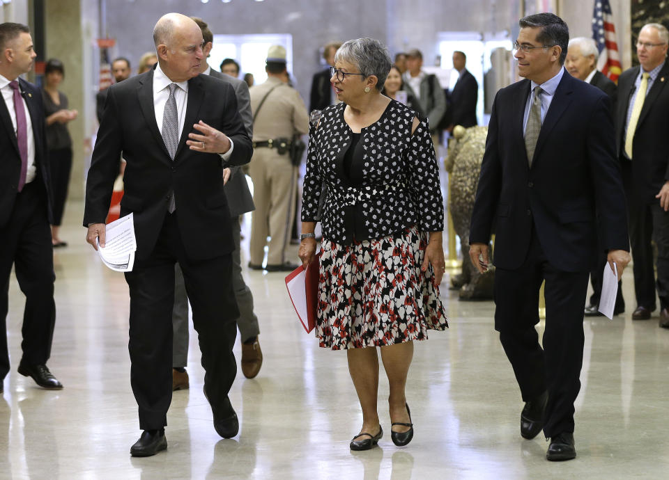 Gov. Jerry Brown, left, talks to California Air Resources Board Chair Mary Nichols and California Attorney General Xavier Becerra as they walk to a news conference to discuss a lawsuit filed by 17 states and the District of Columbia over the Trump administration’s plans to scrap vehicle emission standards Tuesday, May 1, 2018, in Sacramento, Calif. (Photo: Rich Pedroncelli/AP)