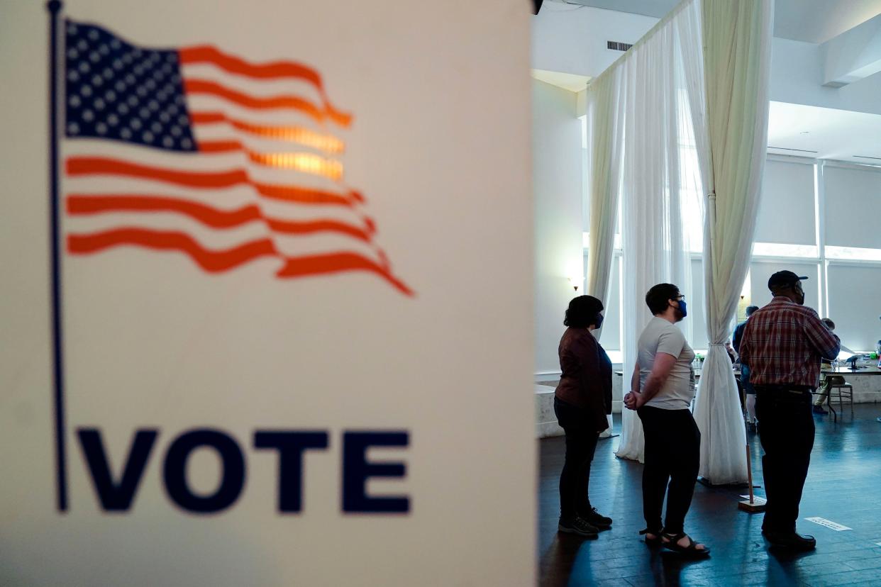 People wait in line to vote in the Georgia's primary election on Tuesday, May 24, 2022, in Atlanta. 