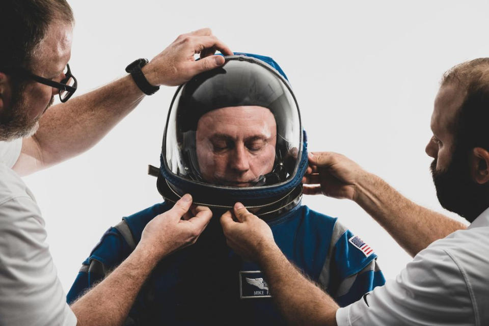 Runner up: NASA astronaut Mike Fincke is pictured being readied by suit technicians ahead of an official portrait in his 'Boeing Blue' spacesuit