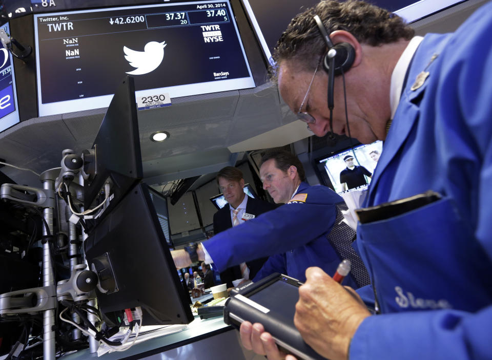 Trader Steven Kaplan, right, works at the post that handles Twitter, on the floor of the New York Stock Exchange, Wednesday, April 30, 2014. Shares of Twitter dropped in morning trading Wednesday to their lowest point since the company went public in November. Investor concern remains over the short messaging service's ability to keep adding users and keep existing users engaged. (AP Photo)