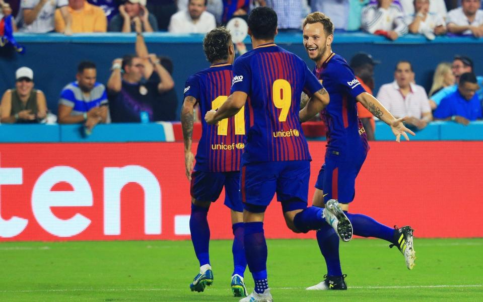 Ivan Rakitic #4 of Barcelona celebrates his goal with teammates Neymar #11 and Luis Suarez #9 in the first half against the Real Madrid during their International Champions Cup 2017 match at Hard Rock Stadium on July 29, 2017 in Miami Gardens, Florida - Credit: Getty