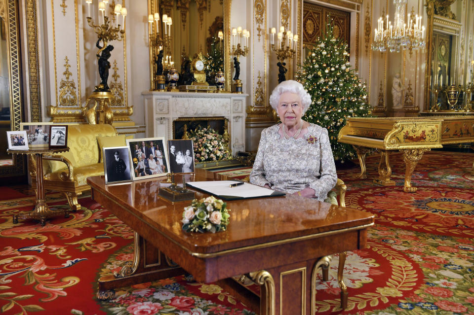 In this image released on Tuesday, Dec. 25, 2018, Britain's Queen Elizabeth poses for a photograph after she recorded her annual Christmas Day message, in the White Drawing Room of Buckingham Palace, London. (John Stillwell/Pool via AP)