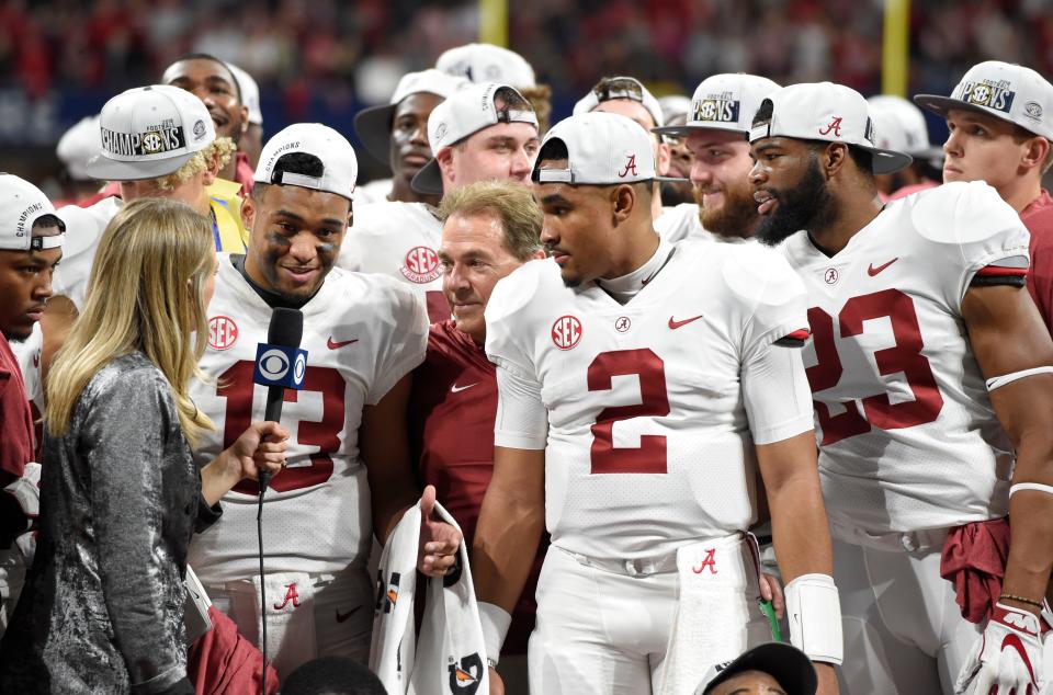 The Alabama Crimson Tide, including QBs  Tua Tagovailoa (13) and Jalen Hurts, and coach Nick Saban. after defeating Georgia in the SEC championship game at Mercedes-Benz Stadium.