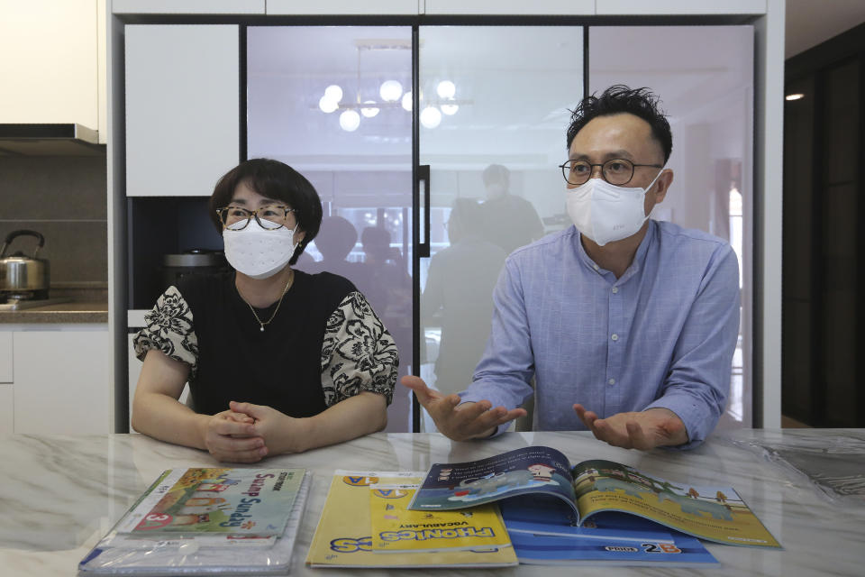 Father Ma Moon Young, right, and mother Choi Hae-jeong of Ma Seo-bin, a high school senior at an elite, speak during an interview at their home in Siheung, South Korea, on Sept. 19, 2020. Ma’s parents, who both work for a private English institute, said they pay about 2 million won ($1,750) a month for their daughter’s private education and 20 million won ($17,550) a year for her schooling and dorm fee. While it is a burden, they said it's worth the expense given how important education is to her future. (AP Photo/Ahn Young-joon)