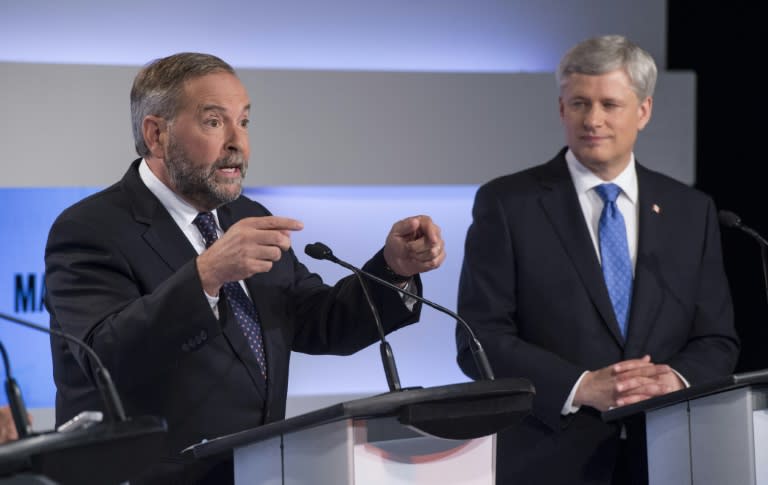 Conservative leader Stephen Harper listens to NDP leader Thomas Mulcair make a point during the first leaders debate on August 6, 2015, in Toronto, Canada