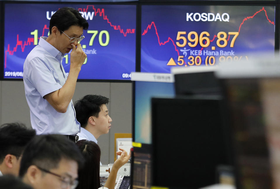 A currency trader watches monitors at the foreign exchange dealing room of the KEB Hana Bank headquarters in Seoul, South Korea, Monday, Aug. 19, 2019. Asian shares were higher Monday, as investors continue to rejigger their read on President Donald Trump's trade war and growing worries about slowing economies around the world. (AP Photo/Ahn Young-joon)