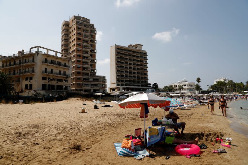 FILE PHOTO: Abandoned buildings in Varosha, an area fenced off by the Turkish military since the 1974 division of Cyprus, are seen from a beach in Famagusta