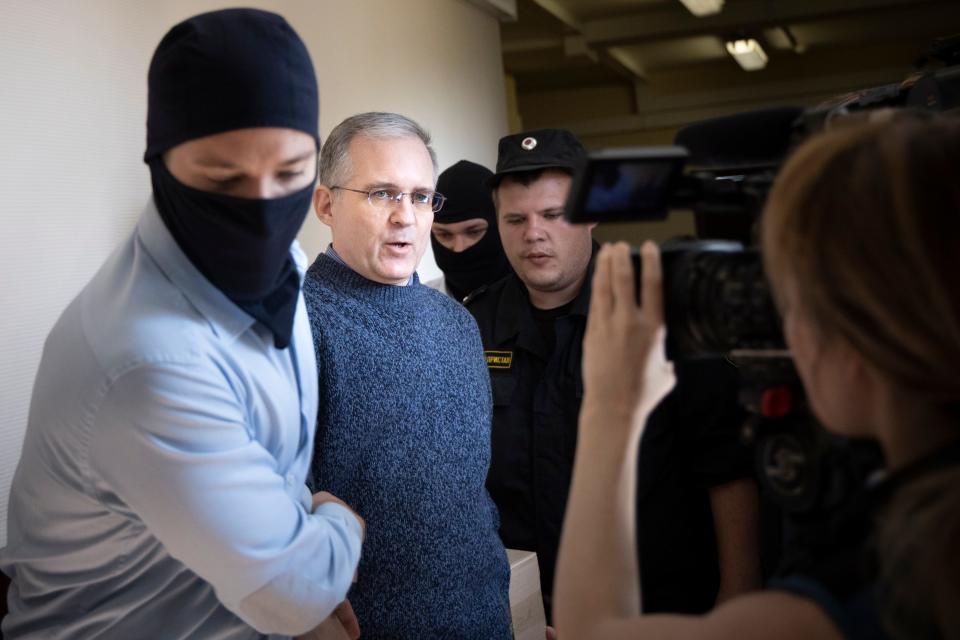 Paul Whelan was arrested and accused of spying in Moscow. He speaks to a journalist as he escorted by Russian Federal Security Service officers into a courtroom in Moscow, Russia, Friday, Aug. 23, 2019.