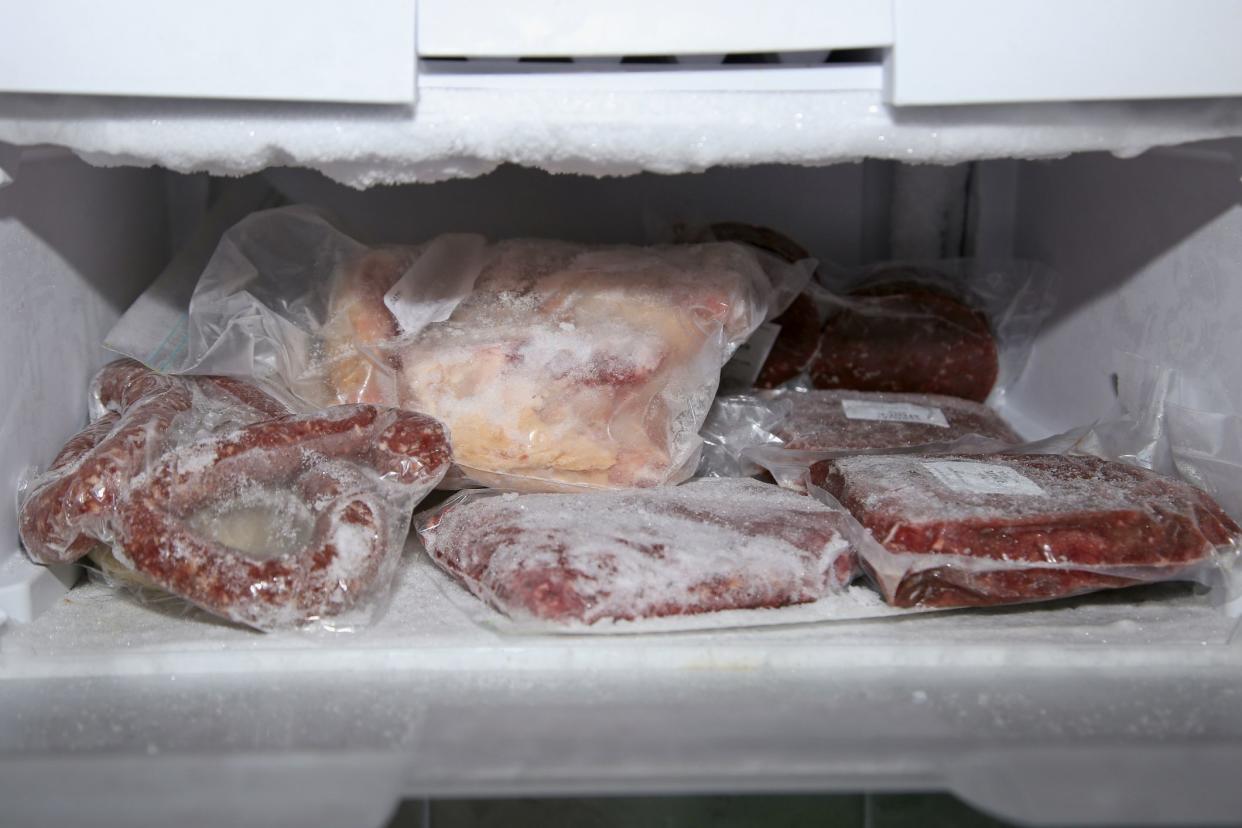 Frozen meat which has been vacuum sealed and placed inside a fridge freezer.