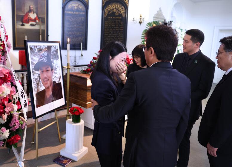 LOS ANGELES, CALIFORNIA May 31, 2024- Jade Lee, left, girlfriend of Yong Yang, is comforted during a memorial service at Forest Lawn cemetery in Los Angeles Thursday. Yang was shot and killed by LAPD officers after a mental health clinician called to report that Yang attacked him. (Wally Skalij/Los Angeles Times)