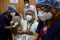 A health worker is being administered COVID-19 vaccine at a hospital in Kolkata, India, Saturday, Jan. 16, 2021. India started inoculating health workers Saturday in what is likely the world's largest COVID-19 vaccination campaign, joining the ranks of wealthier nations where the effort is already well underway. (AP Photo/Bikas Das)